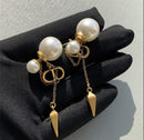 CD logo earrings with chain connect to pearl